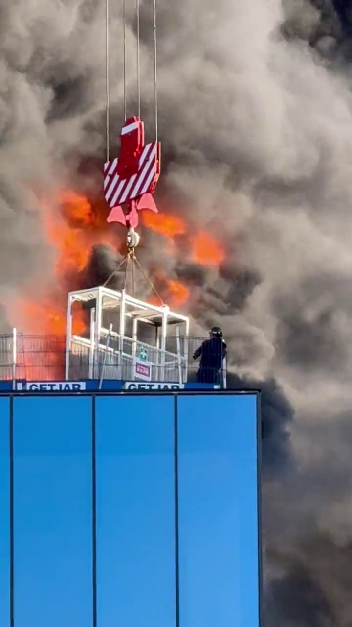 A crane worker who lifted a man to safety from a burning high-rise building in Reading said the rescue was a 'close call' as flames and smoke billowed around him.