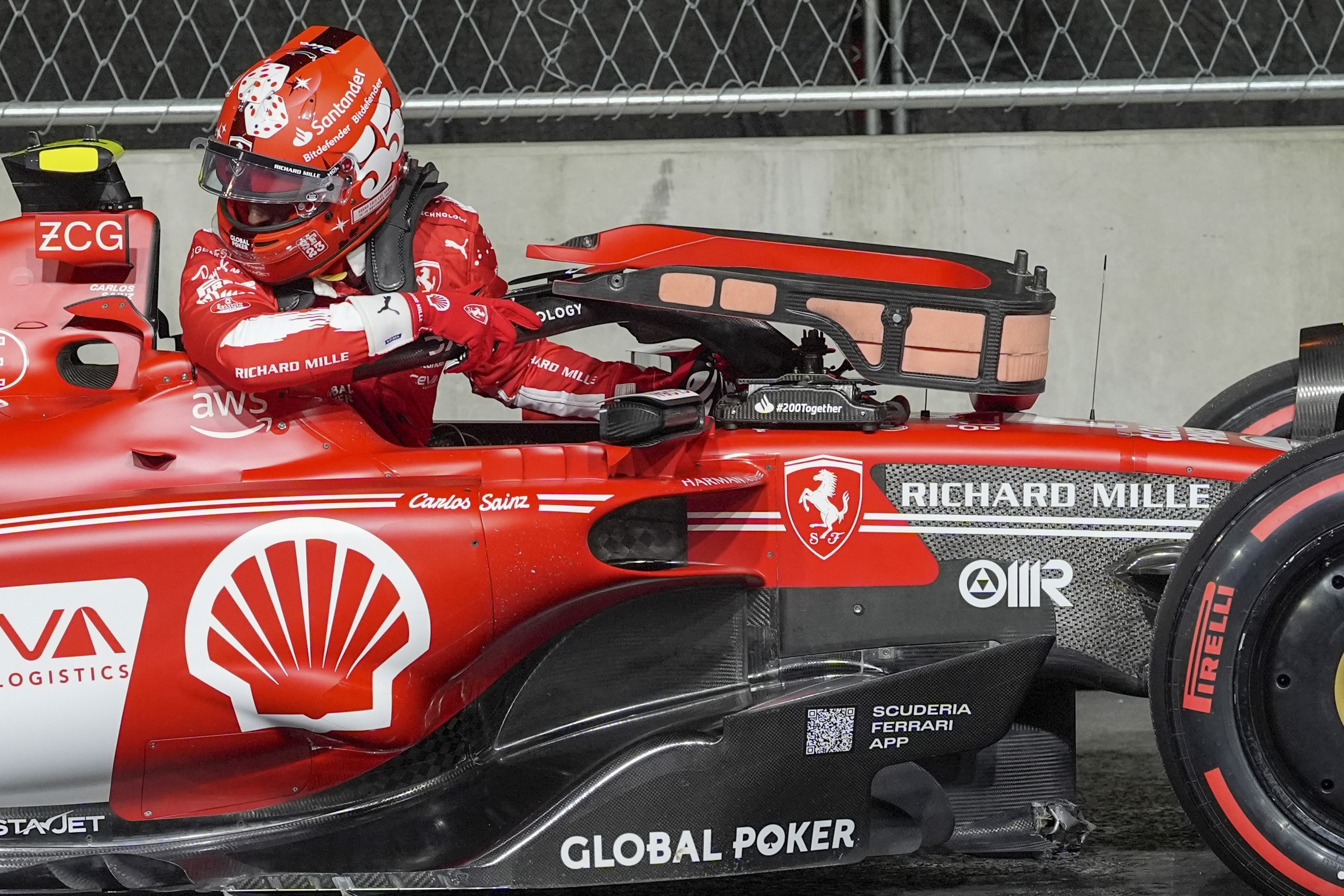 Ferrari driver Carlos Sainz climbs out of his car during the first practice session.