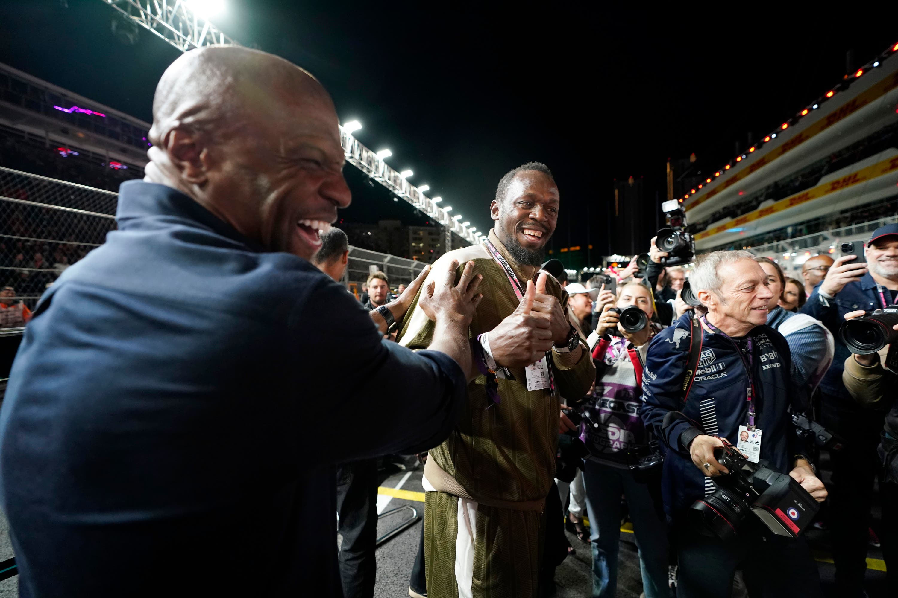 Usain Bolt, right, jokes with actor Terry Crews at the Formula One Las Vegas Grand Prix.