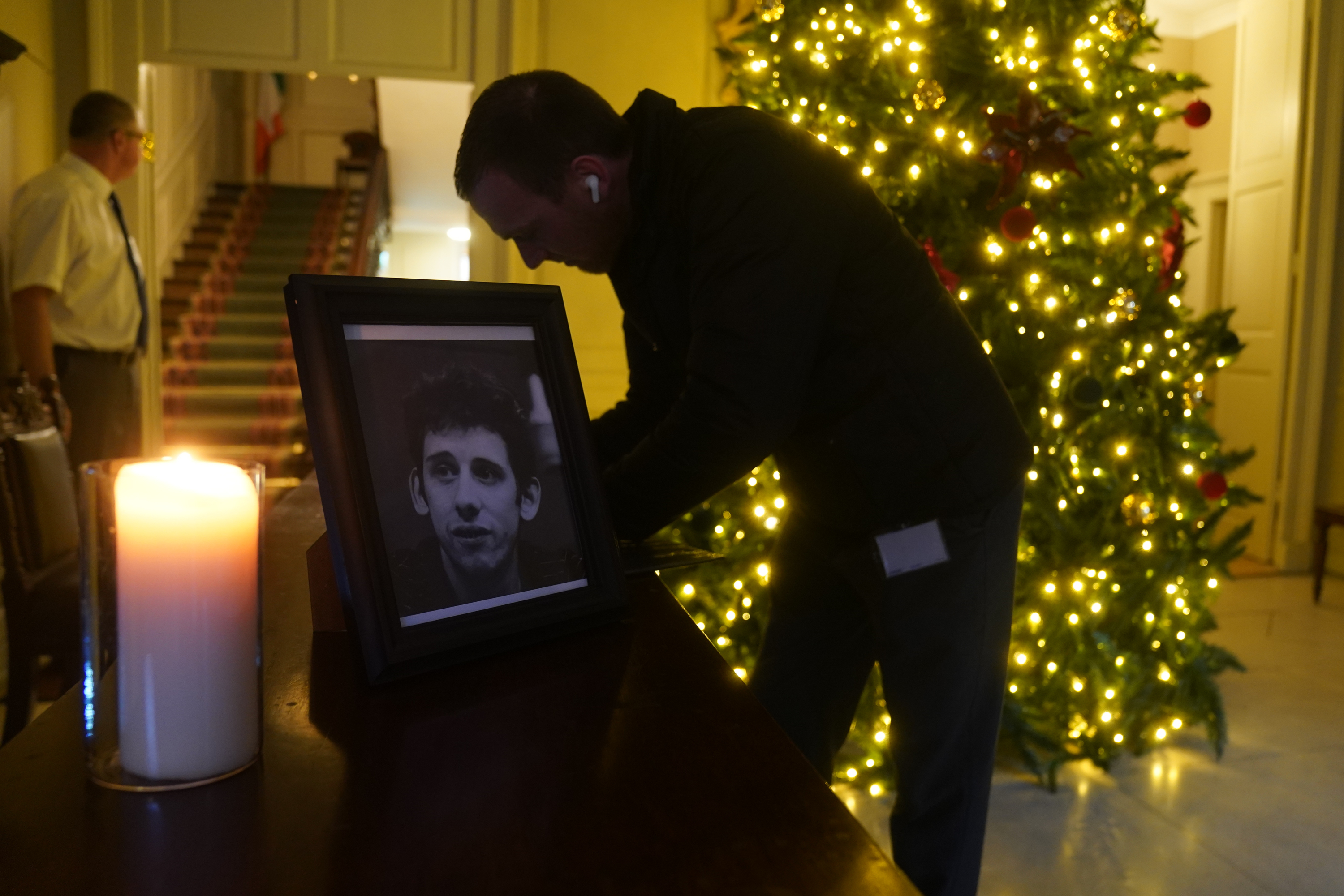A candle burns next to a photograph of The Pogues frontman Shane MacGowan at the Mansion House, in Dublin.