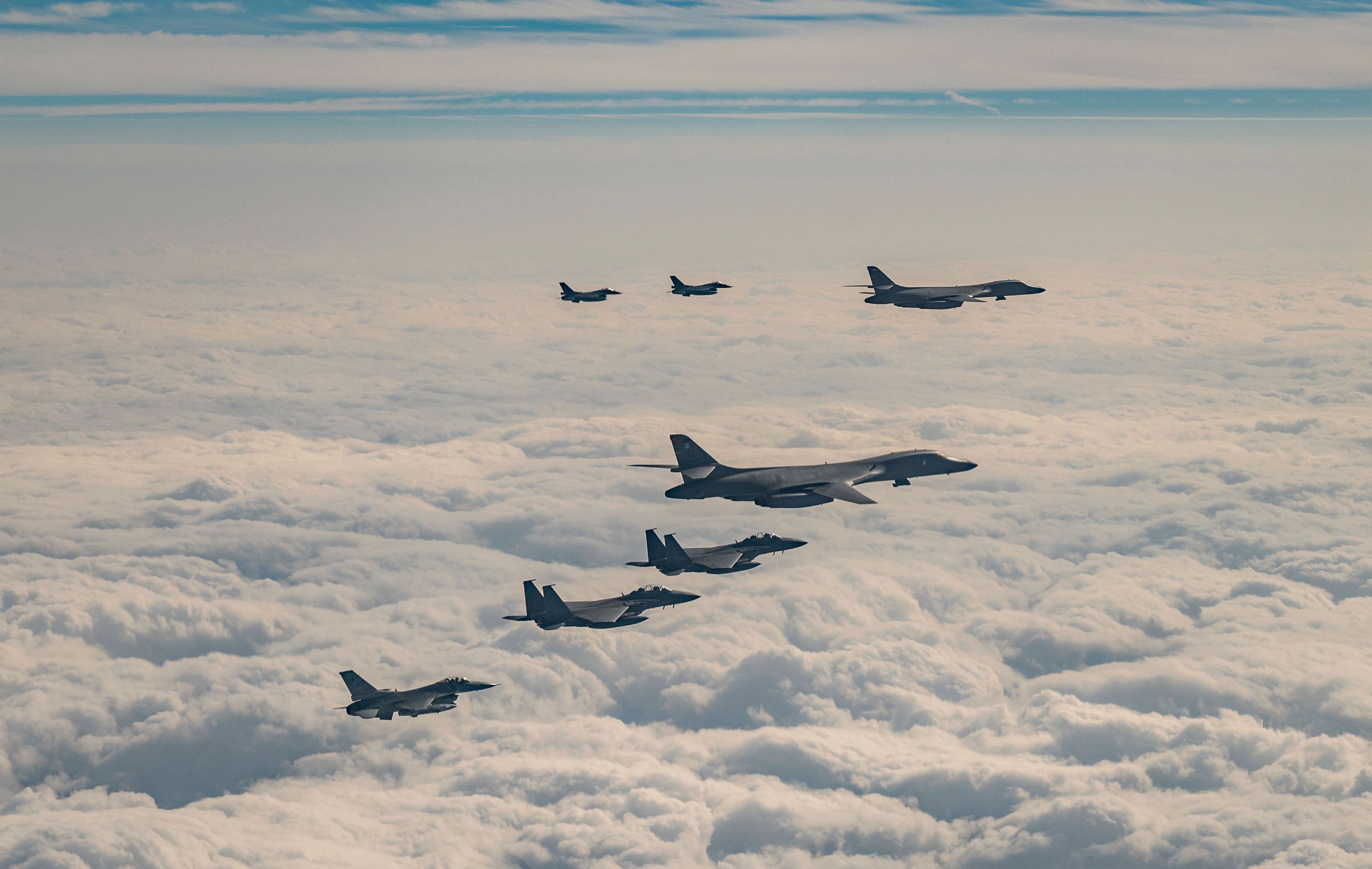 US, South Korean and Japanese fighter jets fly over South Korea’s southern island of Jeju during a joint air drill (South Korea Defence Ministry via AP) 