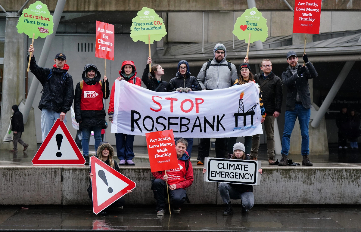 People take part in a Cop28 global day of action at the Scottish Parliament. 