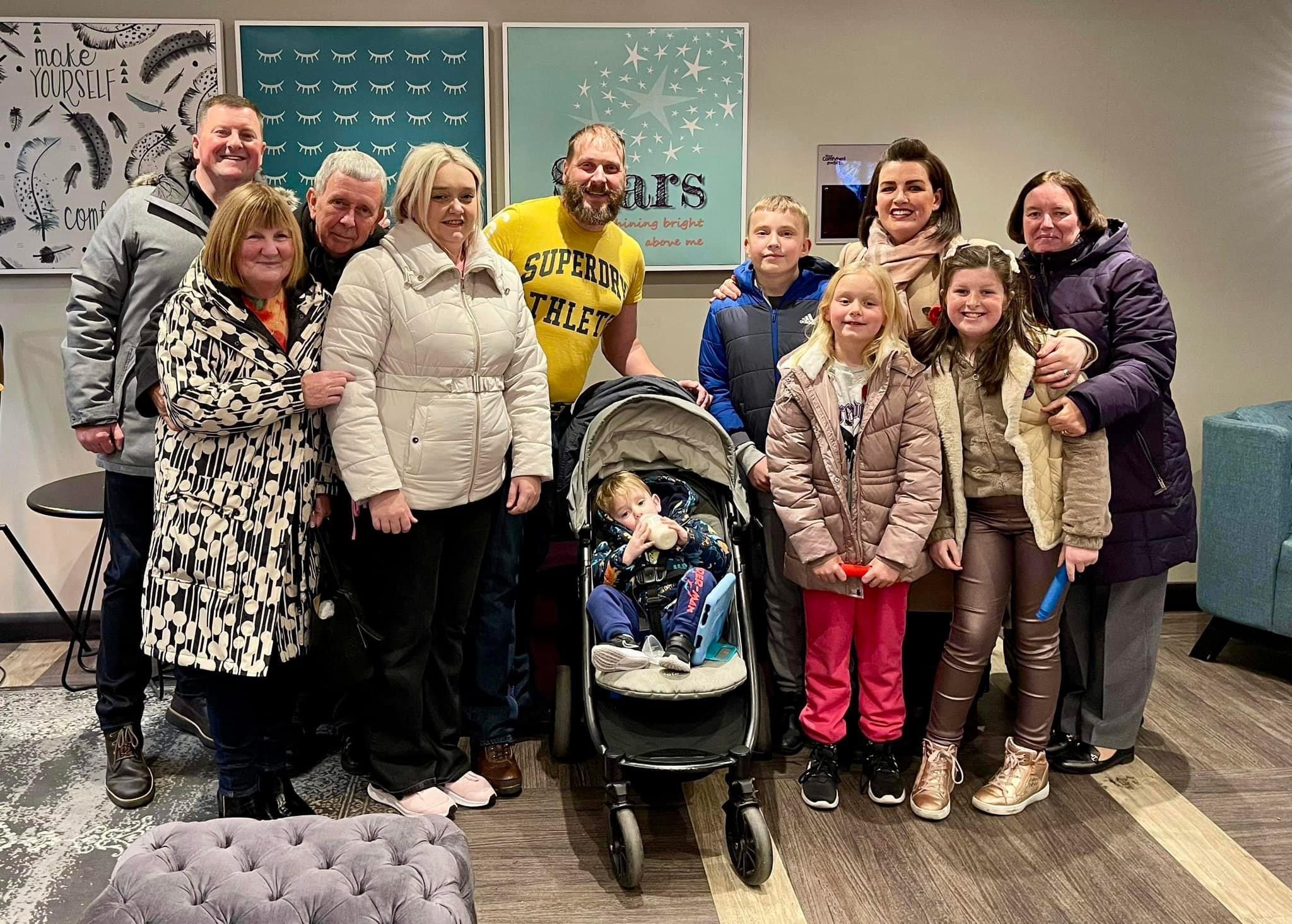 Allan McPike (far left) with Sam Brand (fourth from left) and their families in November (Anthony Nolan/PA).