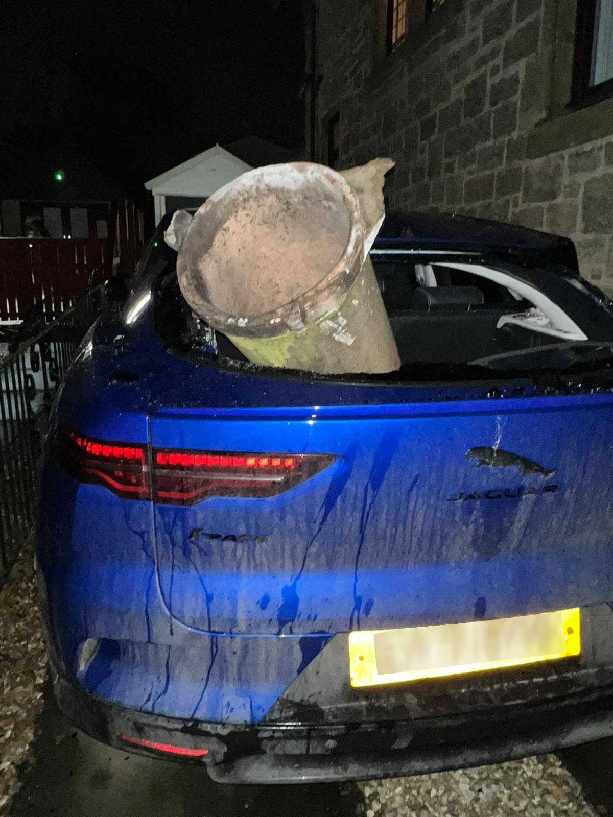 Chimney blown off roof in Airdrie smashing into car.