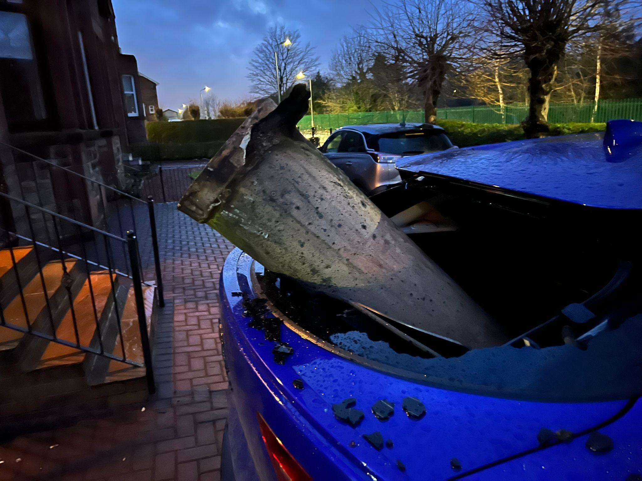 Chimney blown off roof in Airdrie smashing into car's rear windshield.