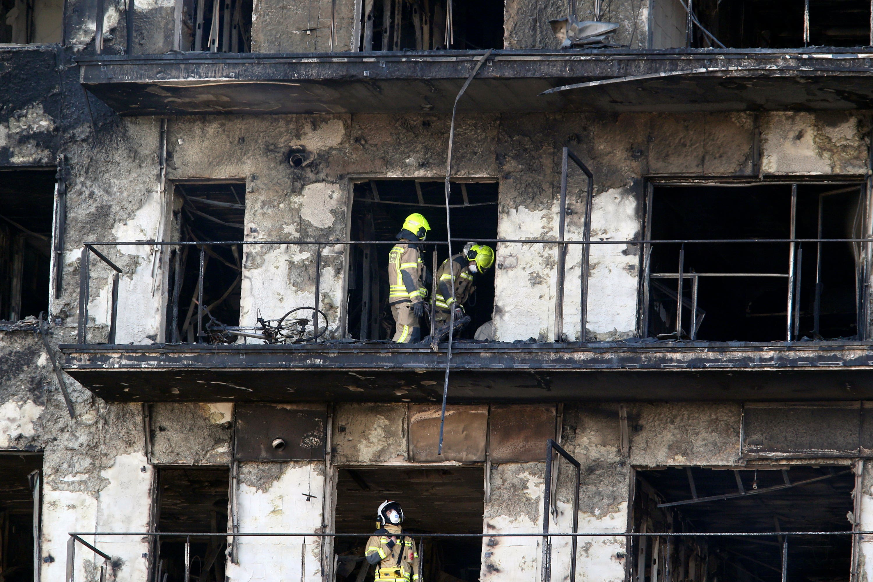 Firefighters work in the building (Alberto Saiz/AP) 