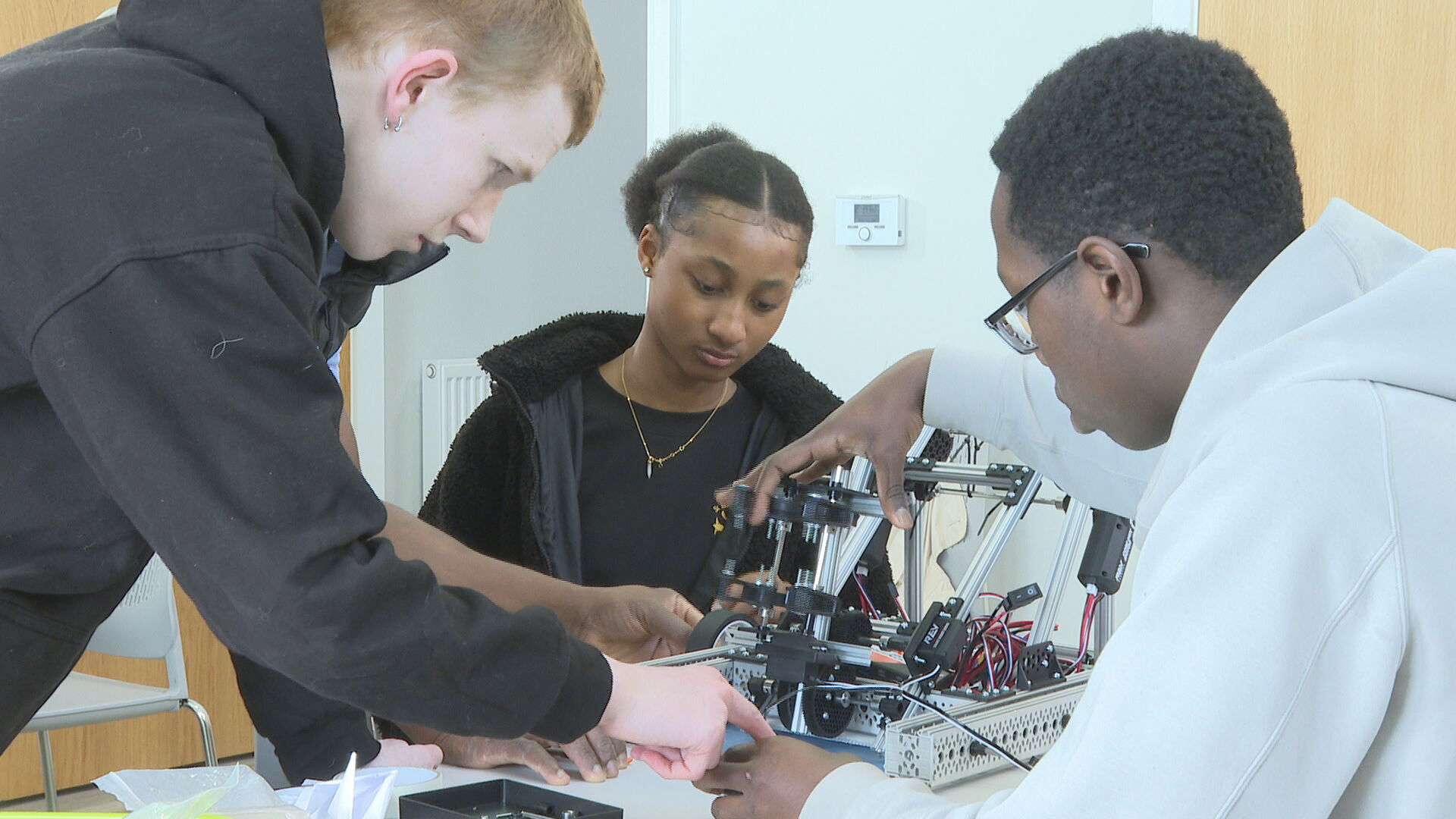 Corey (left) and Daniella (middle) working on their latest robot. 