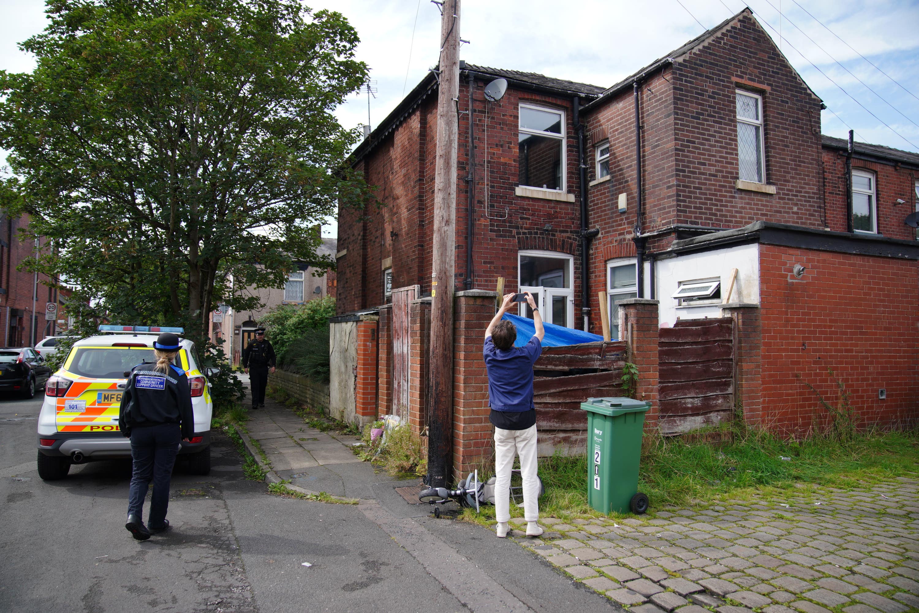 Police officers outside Donald Patience’s property on Ainsworth Road in Radcliffe, Greater Manchester (Peter Byrne/PA). 