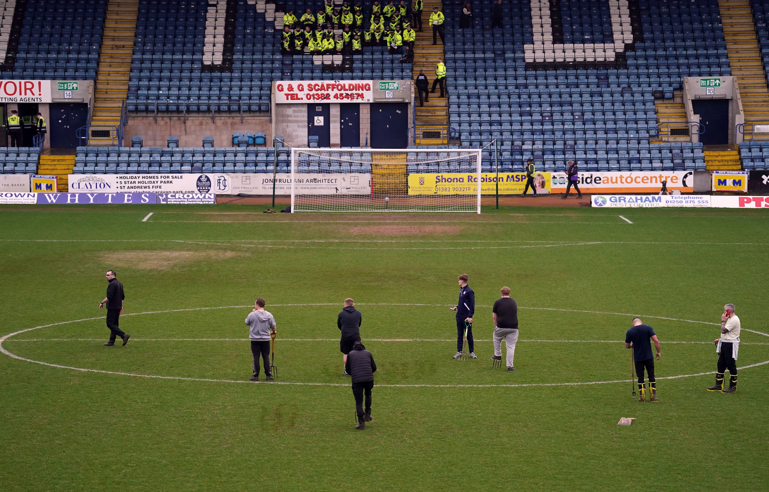 Ground staff work on the pitch (Andrew Milligan/PA).