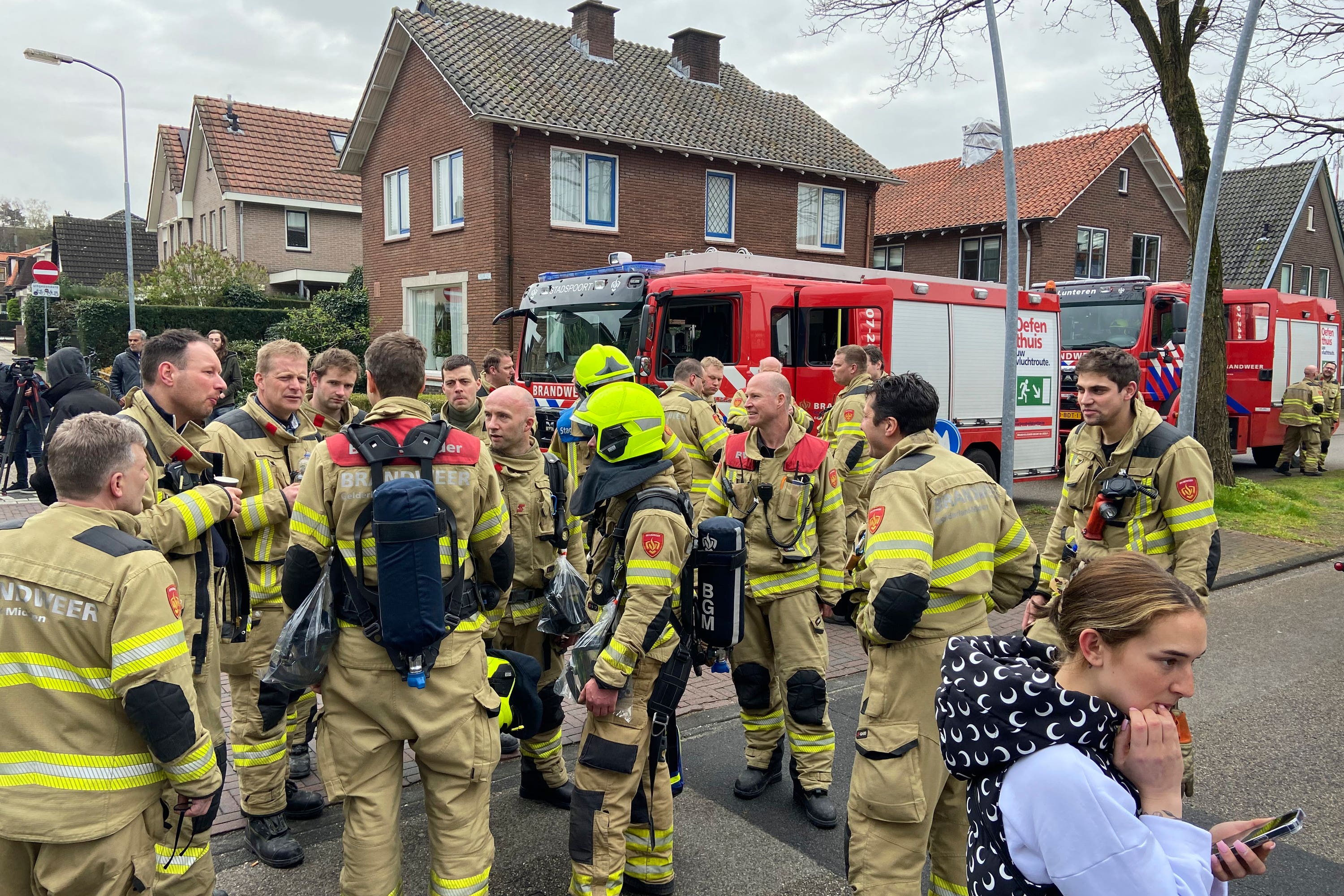 Firefighters gather near the scene.