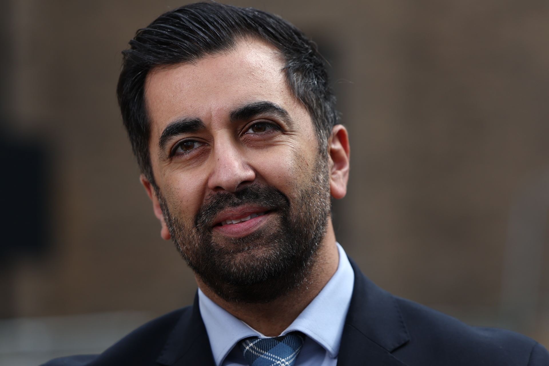 DUNDEE, SCOTLAND - APRIL 26: Scotland's First Minister Humza Yousaf speaks to the media during a visit to a housing development on April 26, 2024 in Dundee, Scotland. The first minister's appearance came as Scottish opposition parties called for a no confidence vote following the collapse of his power-sharing deal with the Green Party.