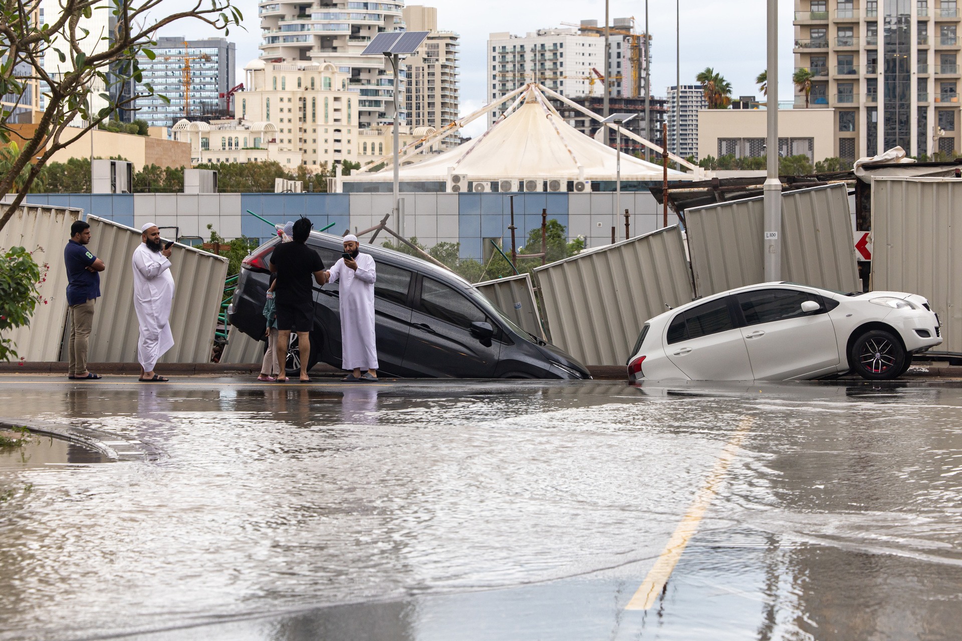 Damaged vehicles after a portion of a roadway collapsed after heavy rainfall in the Dubai Sports City district of Dubai, United Arab Emirates, on Tuesday.