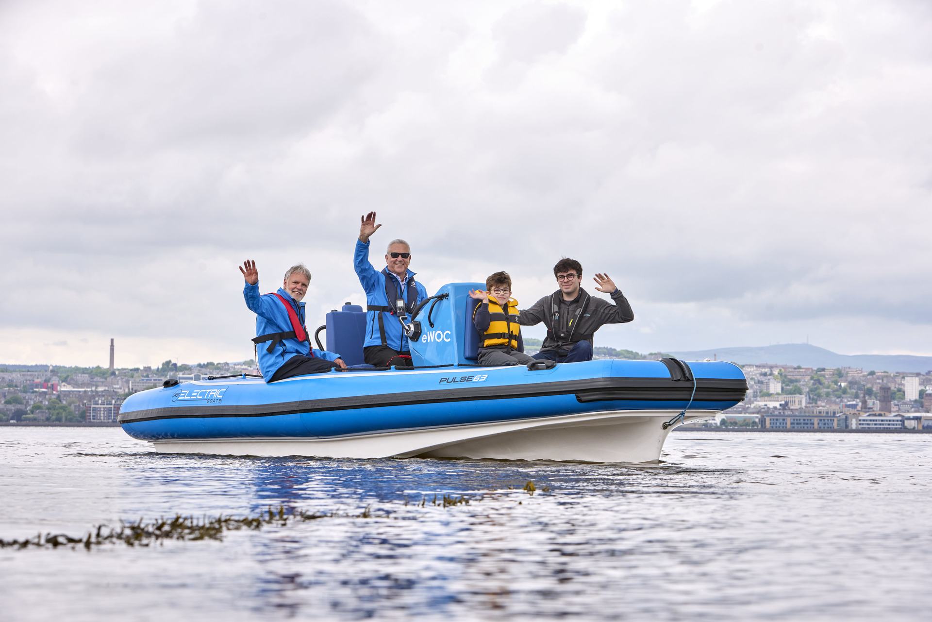 Commodore Ralph Webster (in blue), with Alex Middleton of RS Marine Group (grey jacket), Wormit Primary School pupil Archie Dowdell, and Andrew Lumsden, volunteer RYA Powerboat instructor (sunglasses). Photo by Ross Johnston/Newsline Media.