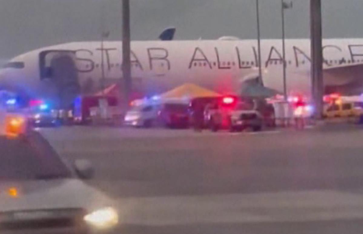 Singapore Airlines passenger jet surrounded by ambulances at Bangkok airport after severe turbulence