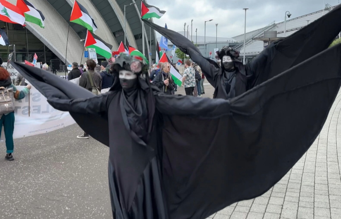 The black-clad silent performers from XR attended the protest.  