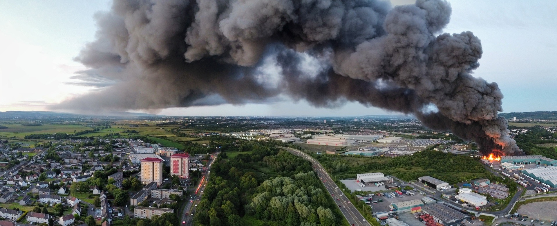 A massive plume of smoke engulfed the sky west of Glasgow after a fire erupted near an industrial estate in Paisley.