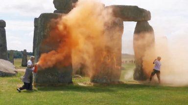 Stonehenge sprayed with orange powder paint by Just Stop Oil activists