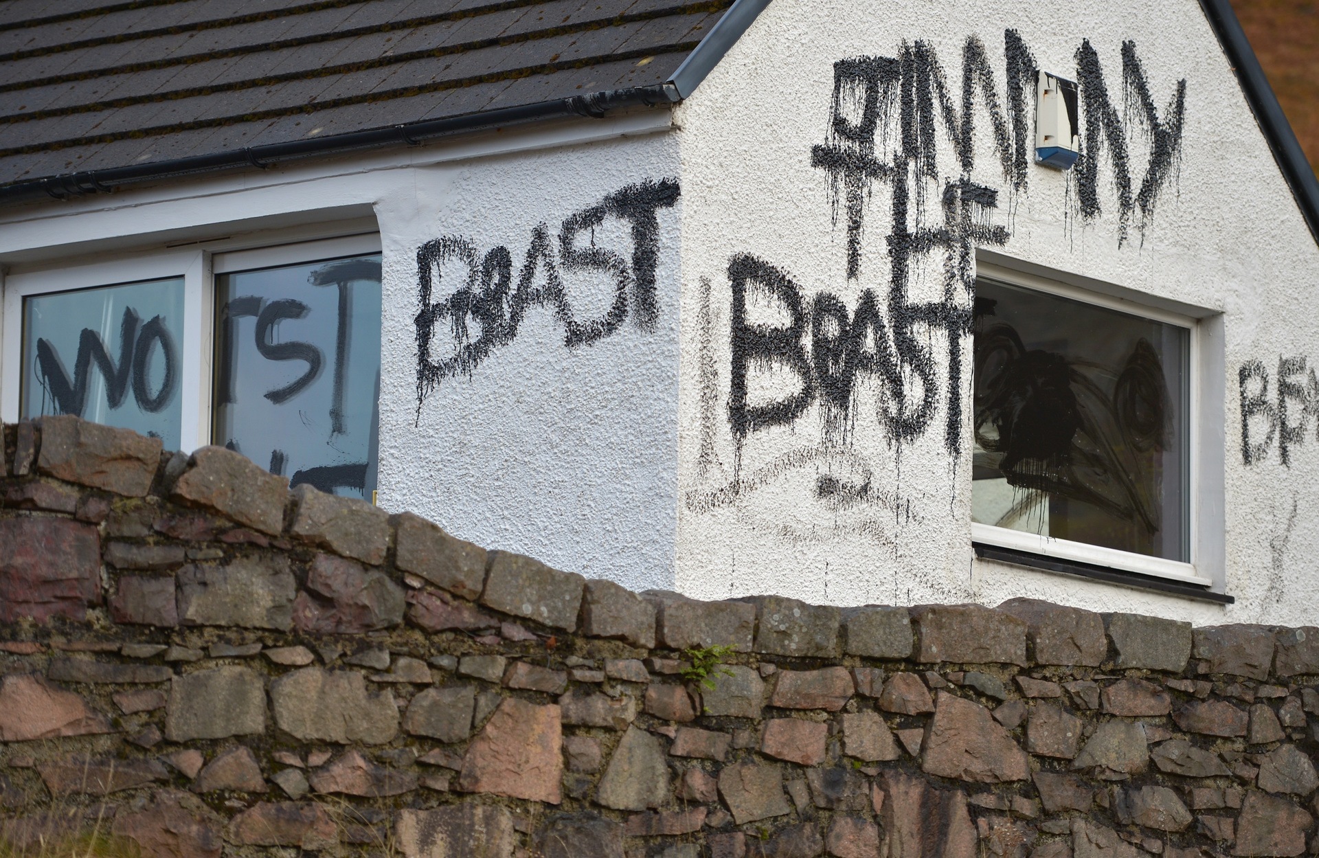 Slogans painted on Alt-na-reigh, the cottage owned by Jimmy Savile, situated next to the A82 road that runs from Fort William to Glasgow.