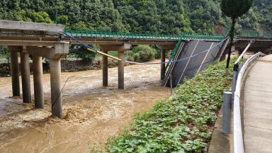 At least 11 dead and dozens missing after highway bridge in China collapses