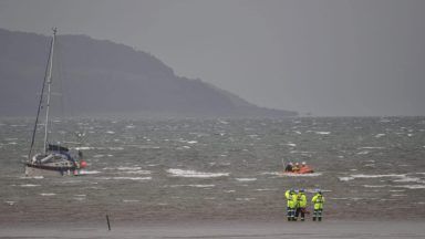 Two people rescued after sailing boat ran aground off coast of Scotland