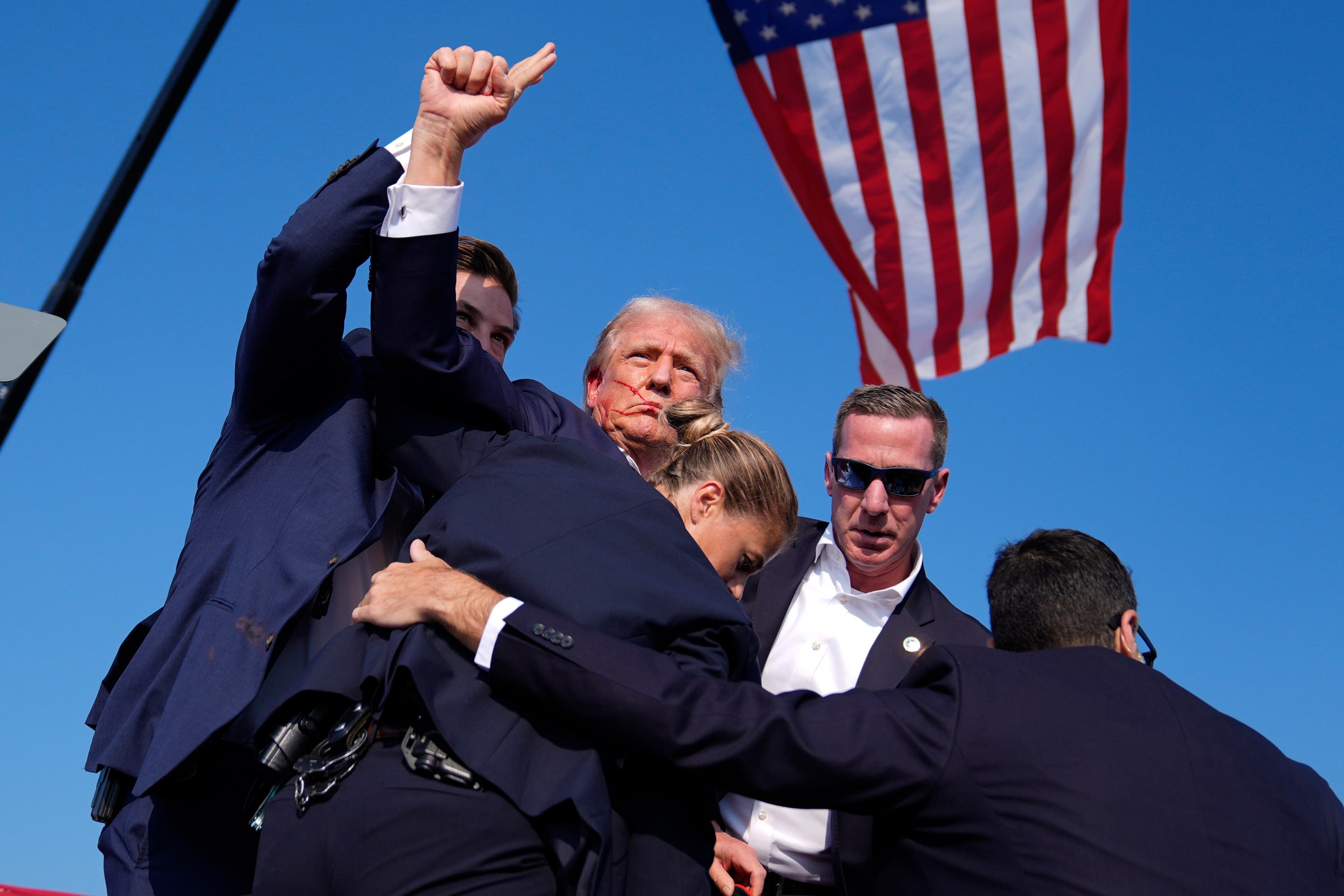 Former President Donald Trump is surrounded by US Secret Service agents (Evan Vucci/AP). 