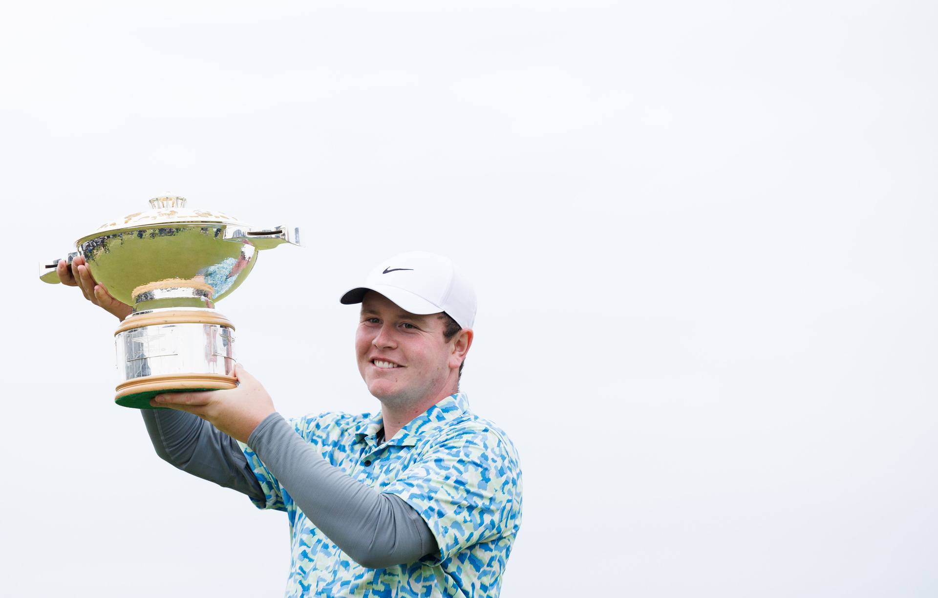 NORTH BERWICK, SCOTLAND - JULY 14: Robert MacIntyre of Scotland, lifts the 2024 Genesis Scottish Open trophy during the 2024 Genesis Scottish Open Fourth Round at The Renaissance Club, on July 14, 2024, in North Berwick, Scotland. (Photo by Ross Parker / SNS Group)