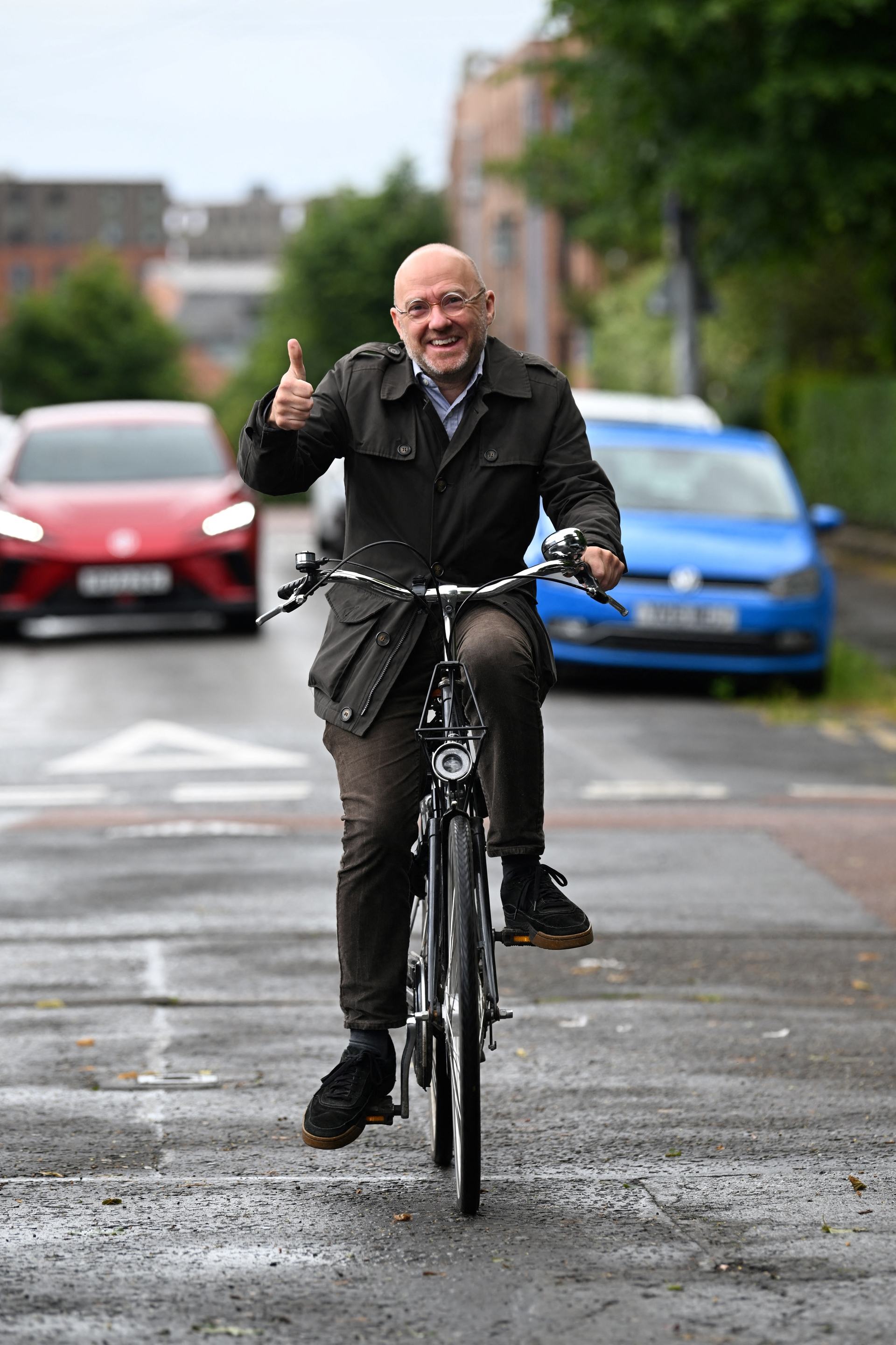 Scottish Green Party co-leader Patrick Harvie gives a thumbs up as he cycles to a polling station at Notre Dame Primary School in Glasgow.