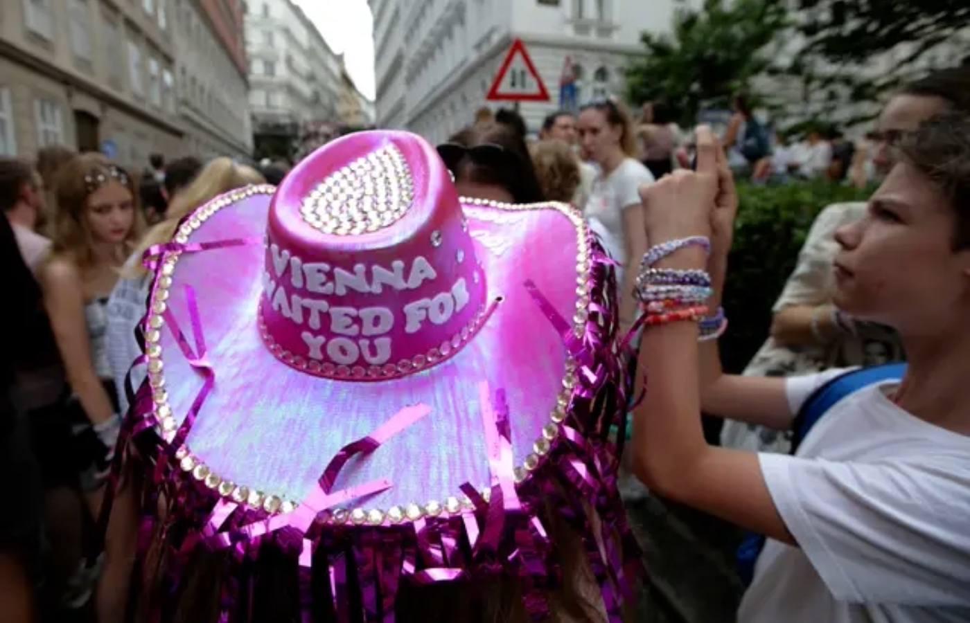 Police kept a watchful eye as hundreds of Taylor Swift fans gathered and sang her songs in the Austrian capital.