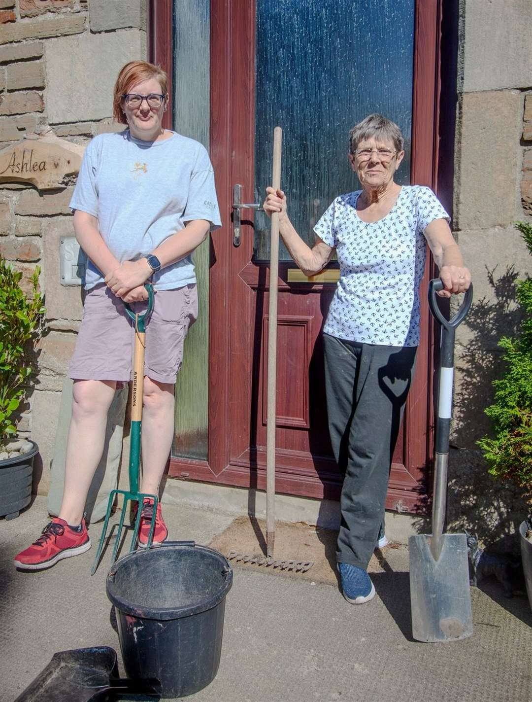 Jenny Paterson (right) and her neighbour Jen MacDonald taking a break from their road repairs this week.