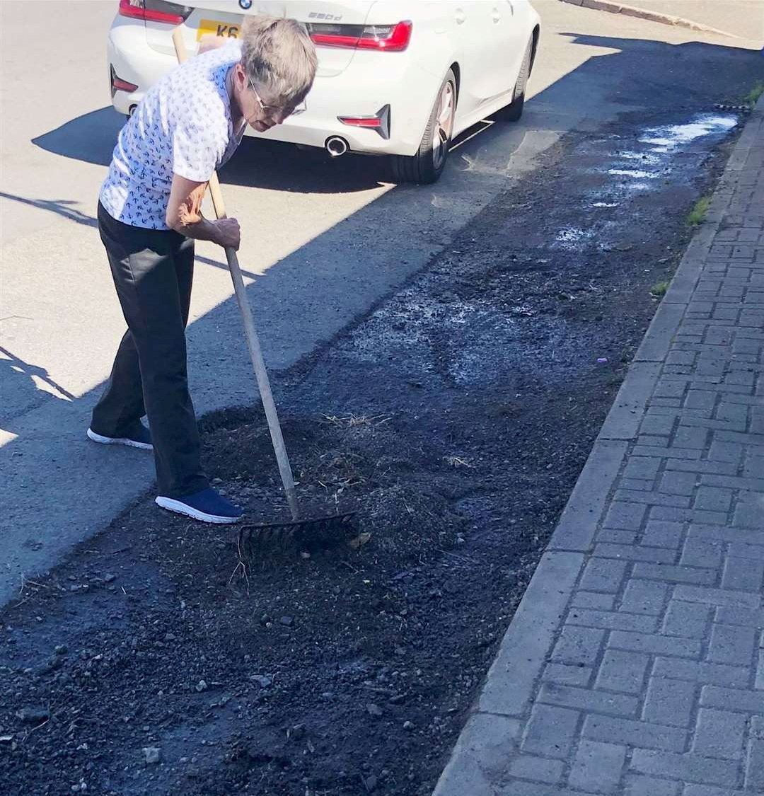 Jenny Paterson hard at work levelling the problem area outside her home in Halkirk.