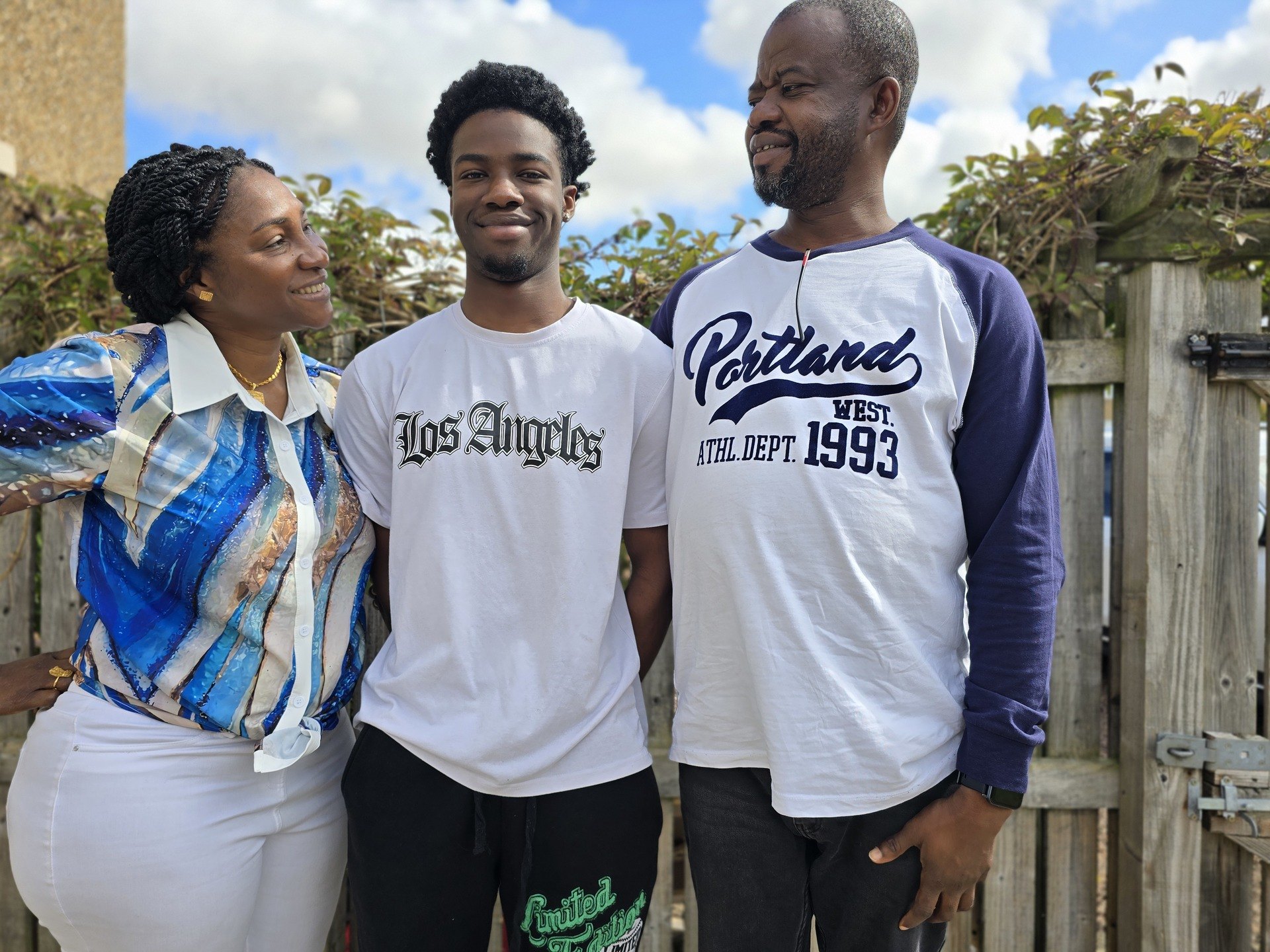 Joram Haruna (centre) pictured with his mum Macrine and dad Kwada.