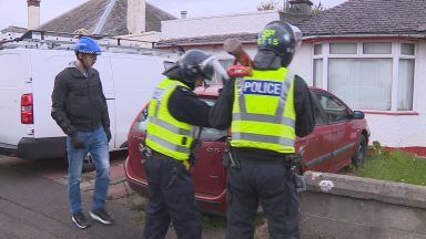 Watch as police raid Dundee home in human trafficking crackdown