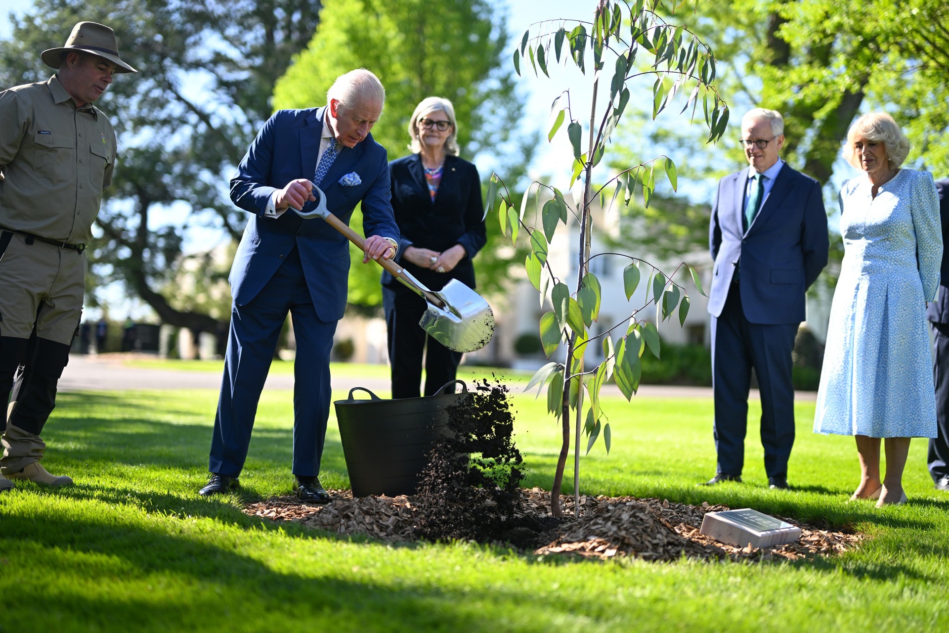 The King and Queen during the ceremonial planting of two snow gum eucalyptus trees in the garden of Government House in Canberra (Victoria Jones/PA). 