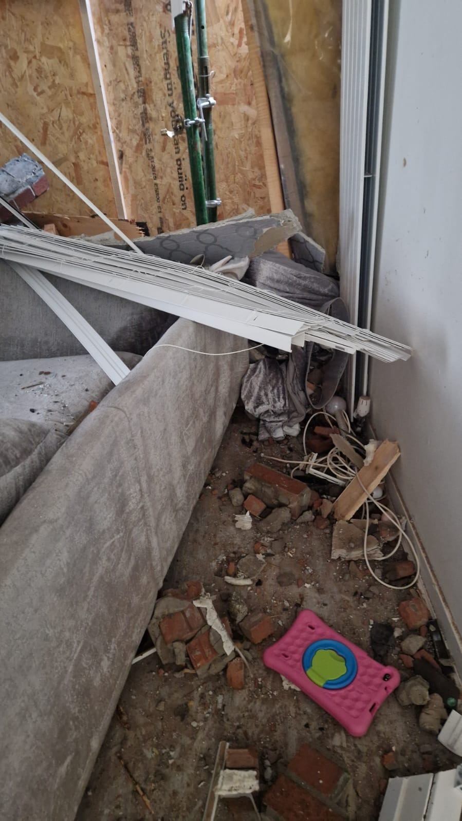 Living room destroyed after car crashes through front of home