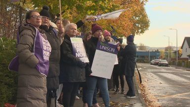 Pressure mounts on Swinney as protesters gather outside constituency office