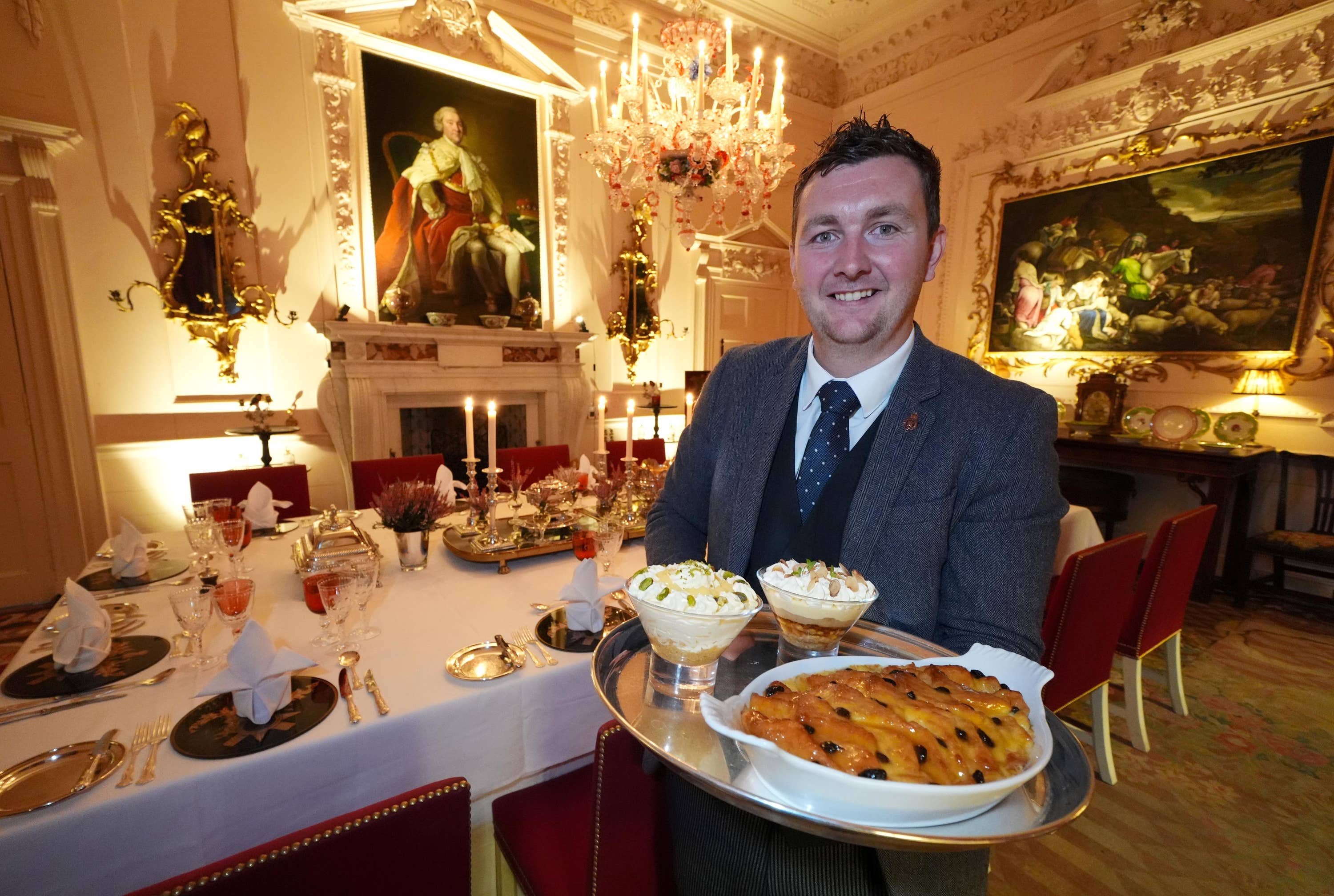 Evan Samson, who leads the front of house team, with a lemon and pistachio syllabub, bread and butter pudding alongside an apple and almond trifle in the Pink Dining Room.