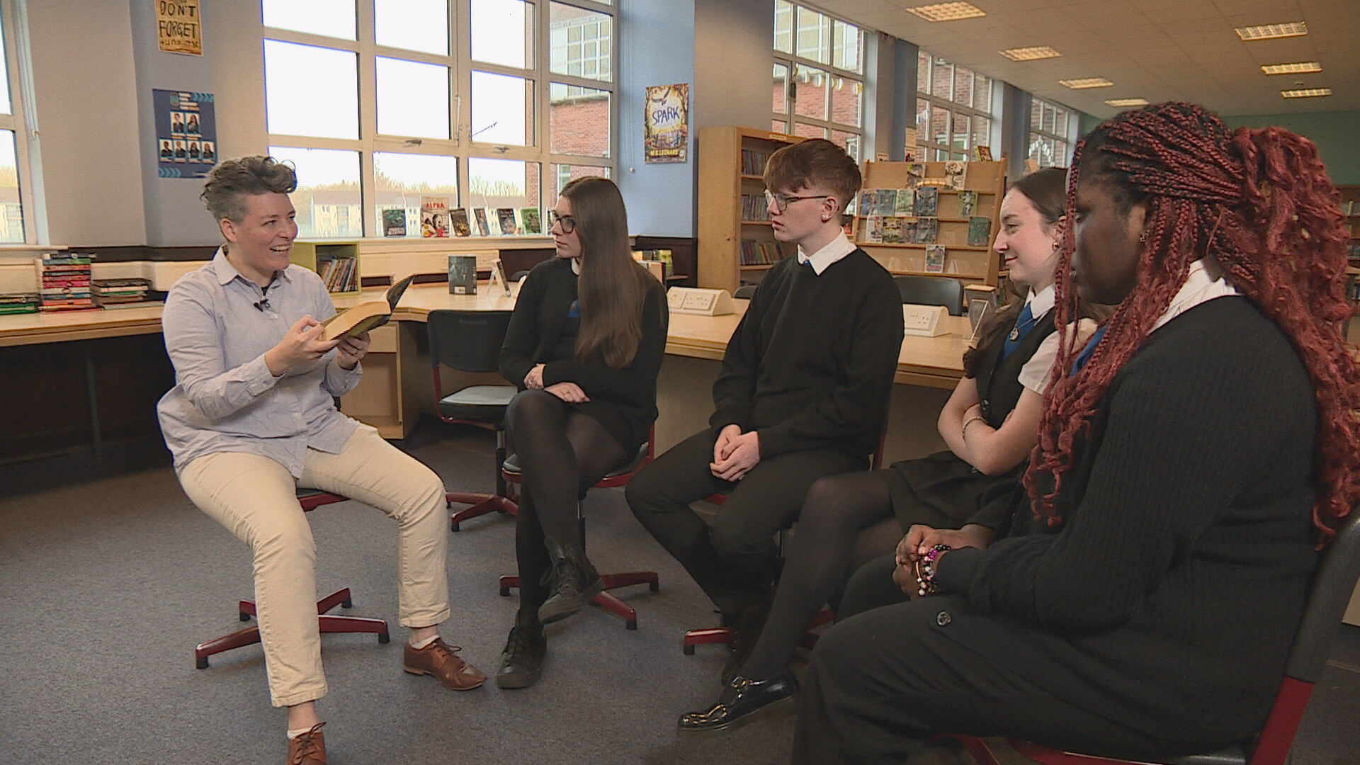 Ely Percy reads to pupils at Lourdes Secondary School