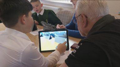 Primary pupils helping the elderly learn tech skills