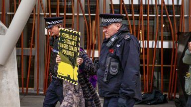 Environmental activists arrested after ‘locking’ themselves to Holyrood in protest of new power plant