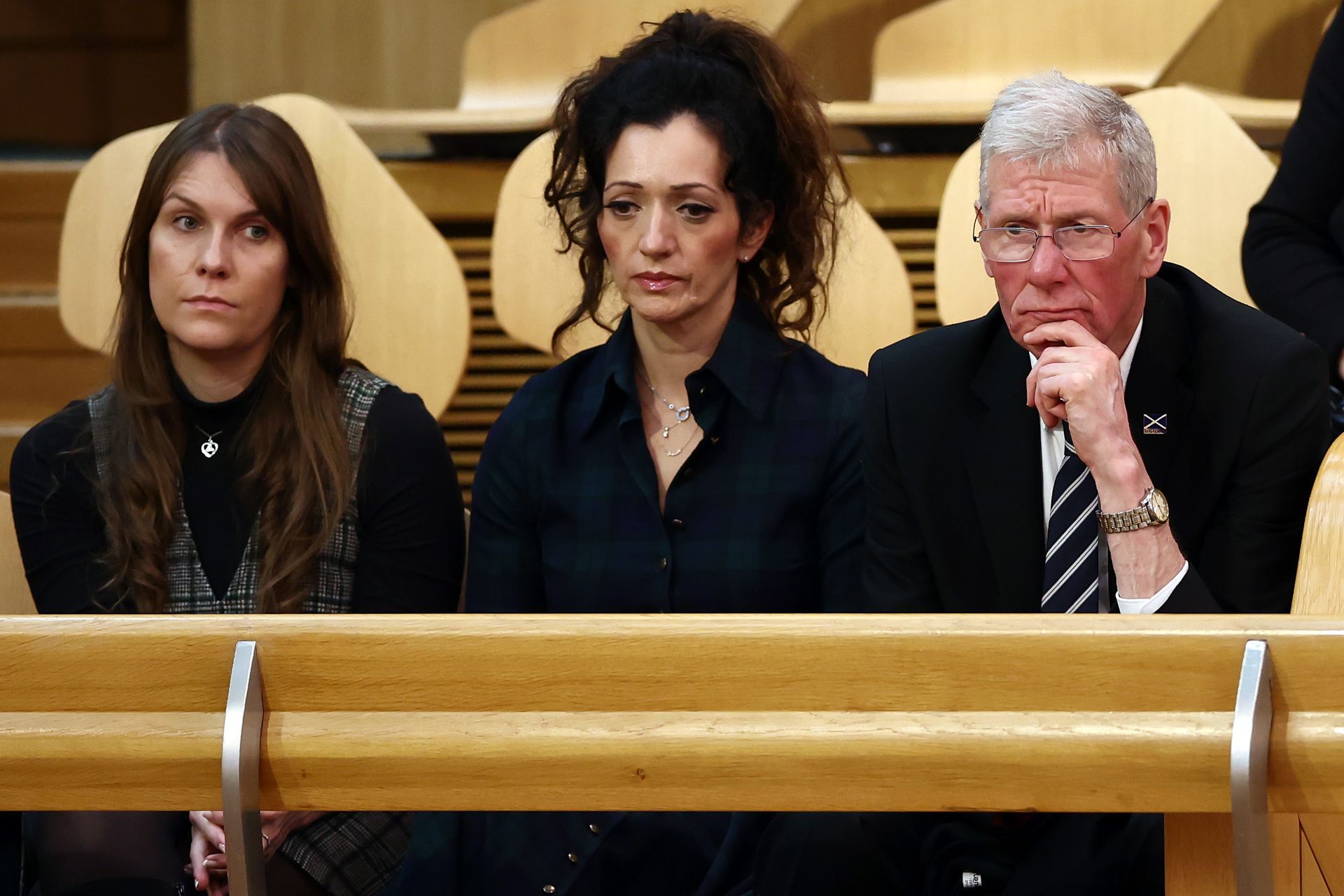 Alex Salmond's niece Christina Hendry (L) Tasmina Ahmed-Sheikh chair of the Alba Party, (C) and acting Alba Party leader Kenny MacAskill during a motion of condolence for Alex Salmond.