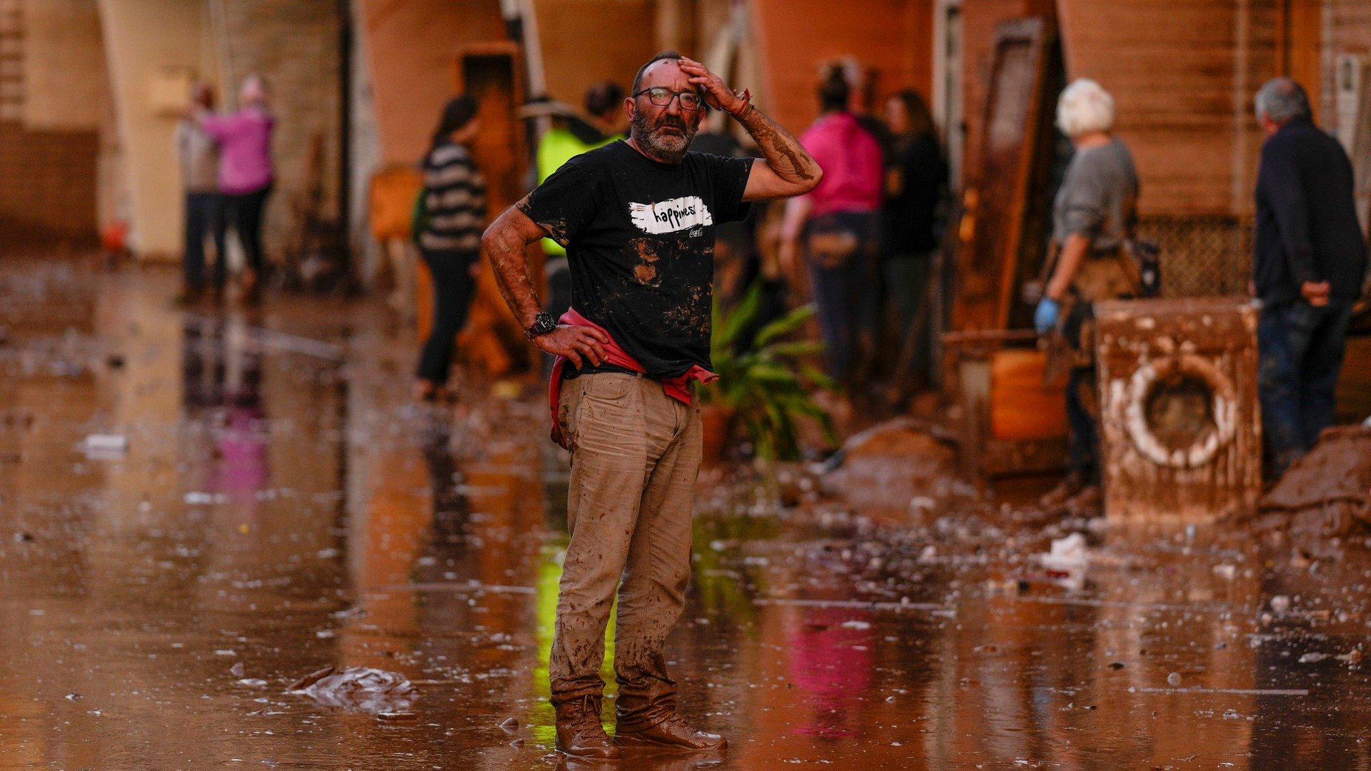 A man reacts in front of houses affected by floods in Utiel, Spain