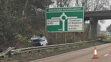 Man taken to hospital after car flips over barrier on Fife motorway