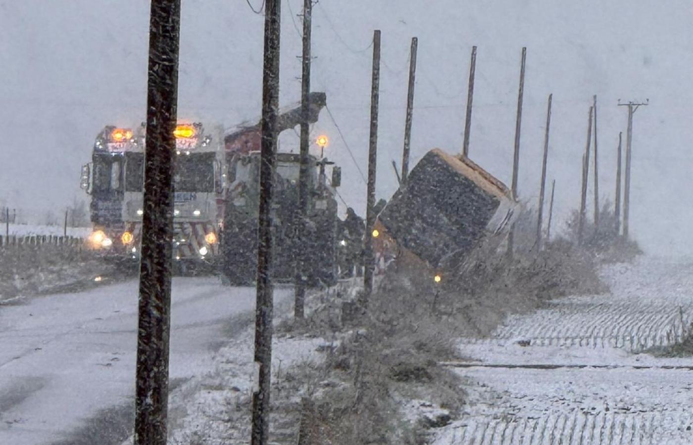 Overturned bus during snowy weather