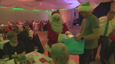 Hibs’ Pat Stanton joins Santa to hand out presents at pensioners’ Christmas party