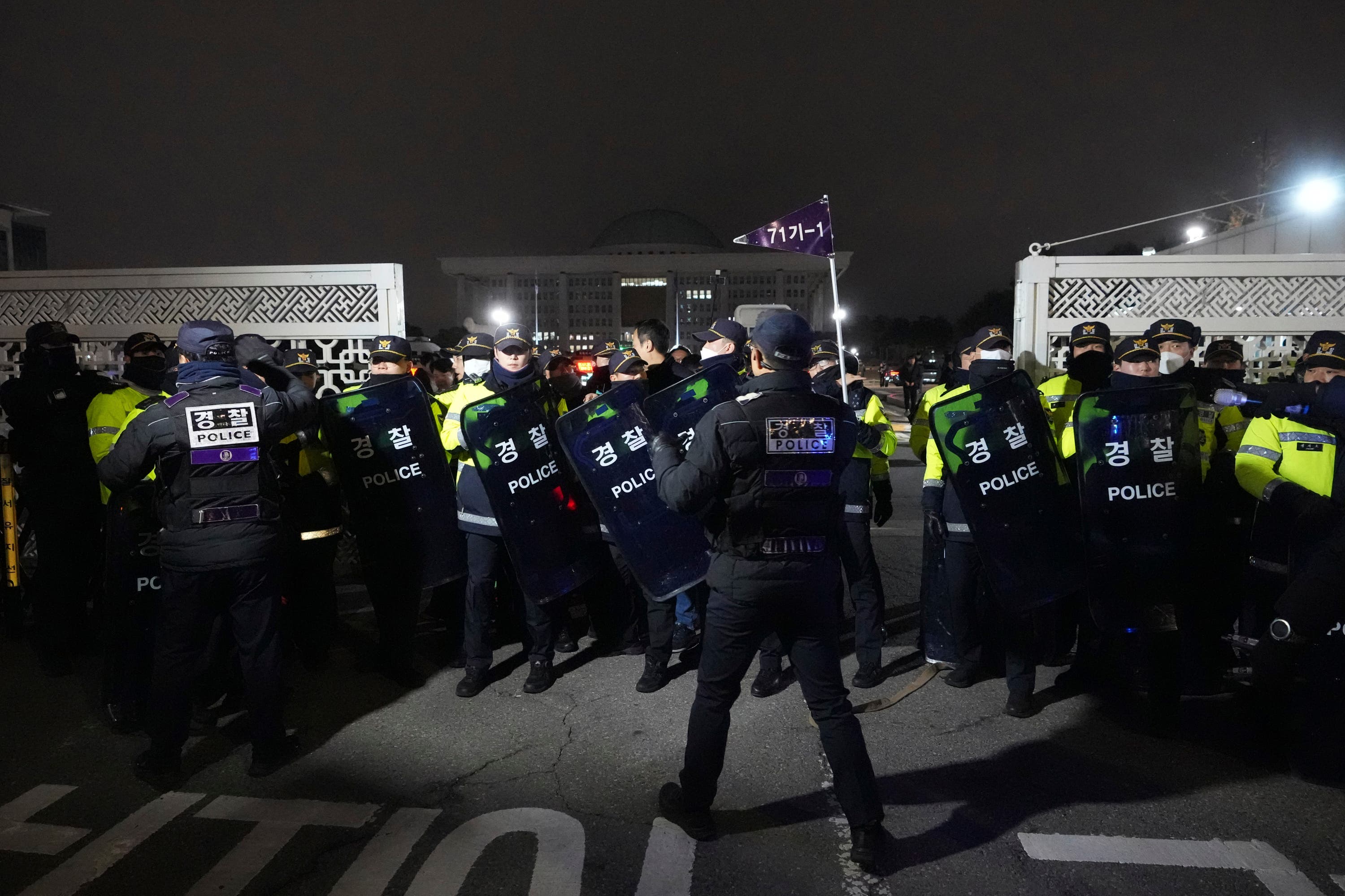 Police officers stand guard in front of the National Assembly in Seoul, South Korea (Lee Jin-man/AP) 