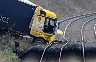 Train services cancelled after lorry crashes onto railway line from A74 near Gretna