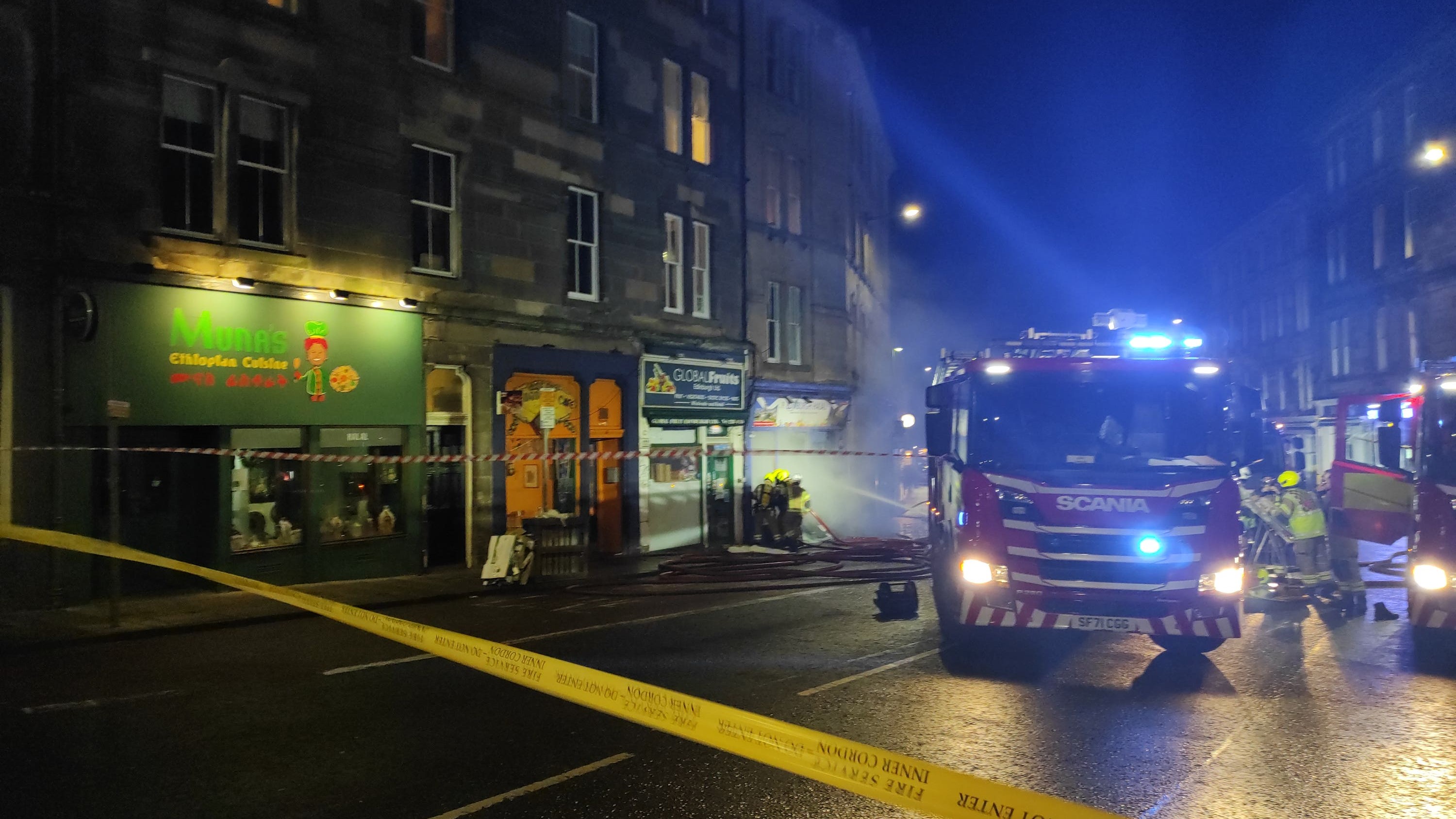 Crews and fire appliances outside Edinburgh Halal, which was first reported to be on fire at about 6.25pm on Saturday