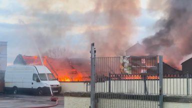 Major fire forces hundreds to evacuate their homes near football stadium