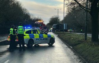 Road closed by police after bus and van get stuck in mud avoiding fallen tree