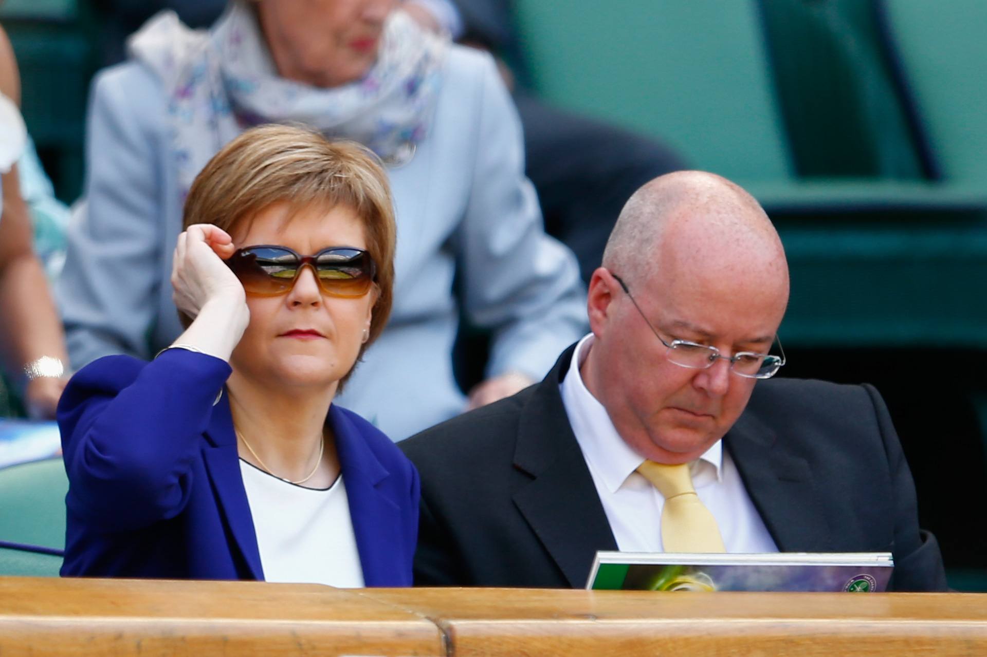 Nicola Sturgeon and her husband Peter Murrell (R) attend day twelve of the Wimbledon Lawn Tennis Championships at the All England Lawn Tennis and Croquet Club on July 11, 2015.